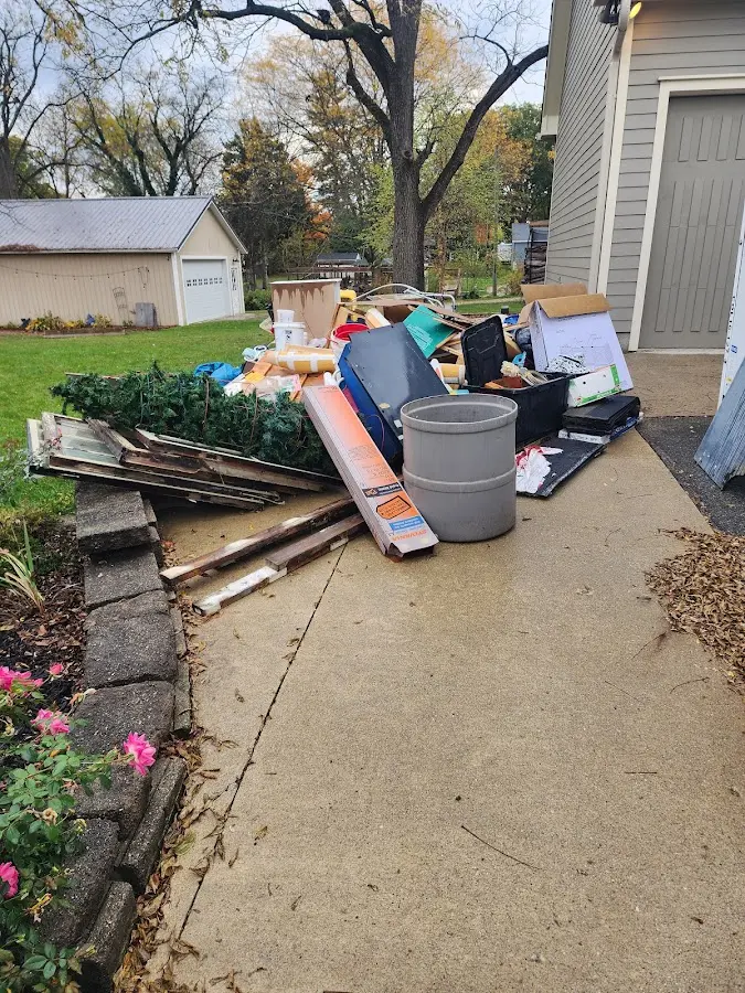 Dumpster being loaded with debris for Roofing Dumpster Rental in Lindsay